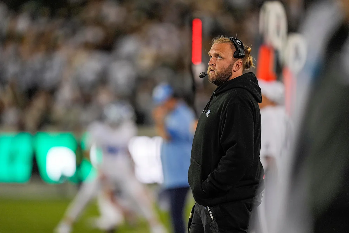 Steve Belichick coaching North Carolina football team during practice